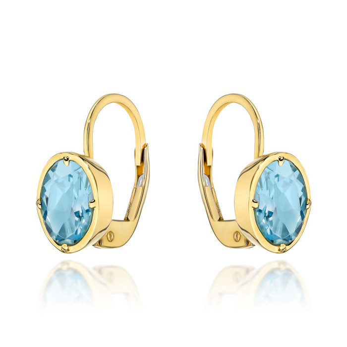 Kolczyki złote 585 14kt niebieski owalny topaz w złotej oprawie na angielskim zapięciu efektowne na prezent Kolczyki złote 585 14kt niebieski owalny topaz w złotej oprawie na angielskim zapięciu efektowne na prezent